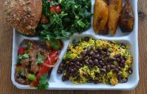 A meal of traditional flavours: Brazil's rice and black beans, baked plantain, pork with peppers and coriander, green salad and a seeded roll