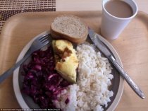 Lunch in an Estonian school is rice with a piece of meat and purple cabbage. They also have bread and a get a cup of chocolate drink