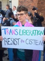 UNC-Chapel Hill grad student Rémy Jodrey holds a sign at the Franklin Street rally in Chapel Hill, N.C. March 29. (Photo: Rémy Jodrey)